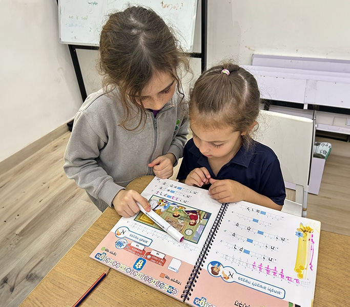Children sitting on the floor and learning with flashcards