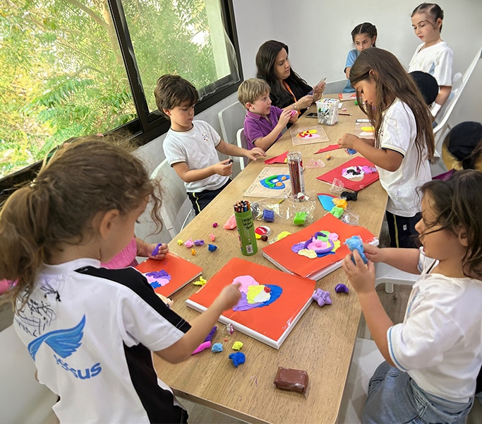 Group of kids working with colorful educational games indoors