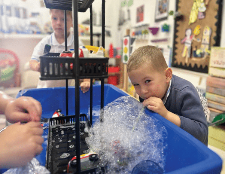 Boy watching 3D printer in action during a tech demonstration