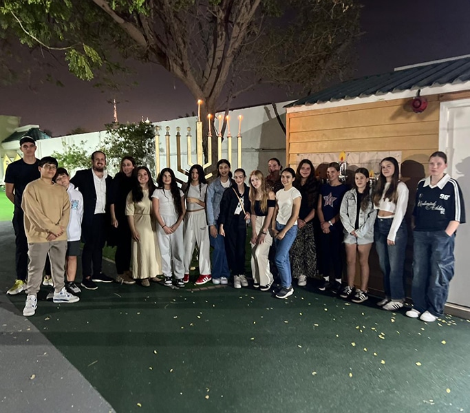 Group photo of parents at an evening event on nursery grounds