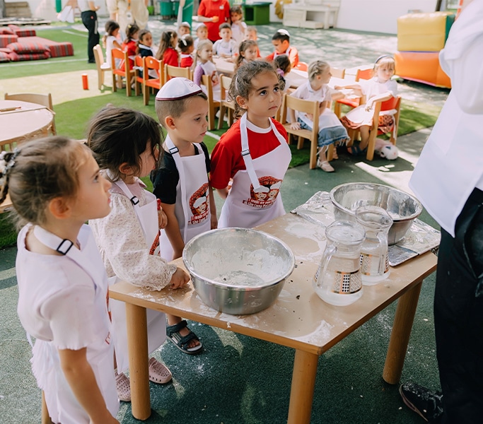 Kids exploring science experiments at a festive table
