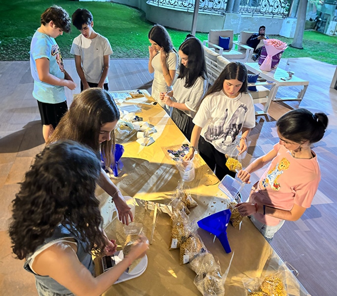 Parents and children participating in an outdoor arts activity